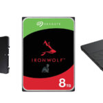 Three storage drives including a Seagate IronWolf 8TB hard drive, a Crucial SSD, and a Samsung SSD arranged for comparison and replacement use