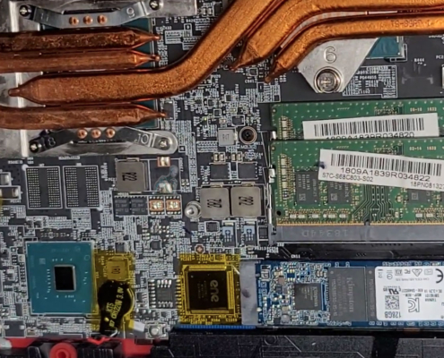 Laptop heatsink installed over CPU and GPU chips showing thermal cooling system inside motherboard