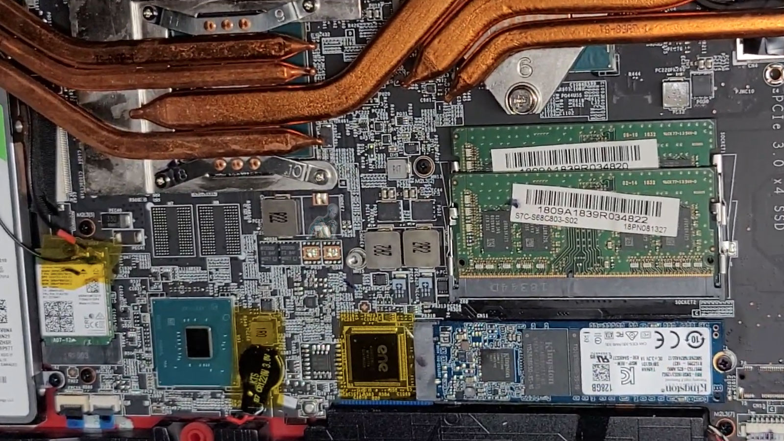 Laptop-Heatsink-Cooling-CPU-and-GPU-Chips Laptop heatsink installed over CPU and GPU chips showing thermal cooling system inside motherboard