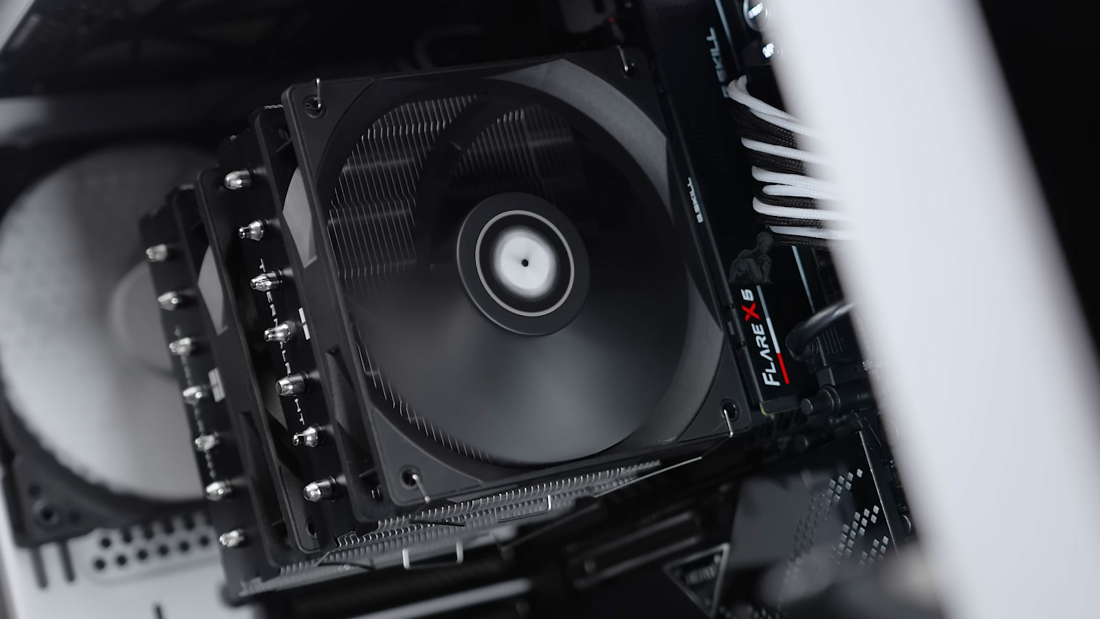 Large CPU heatsink with dual fans actively cooling a gaming PC processor during operation