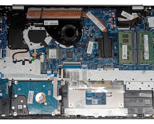 Laptop internal view showing 2.5 inch HDD drive and hardware components with bottom cover removed