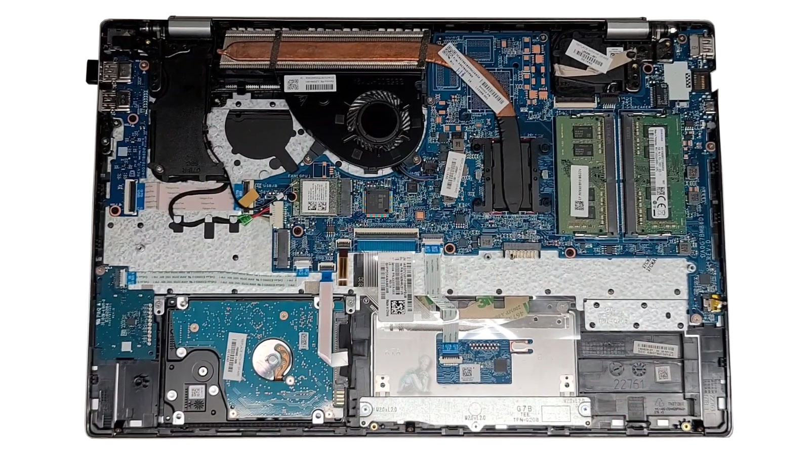 Laptop internal view showing 2.5 inch HDD drive and hardware components with bottom cover removed