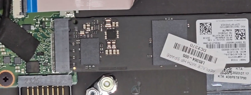 Laptop internal view showing M.2 SSD installed on motherboard