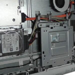 Opened all-in-one computer with internal components exposed while the hard drive is being removed for data recovery work