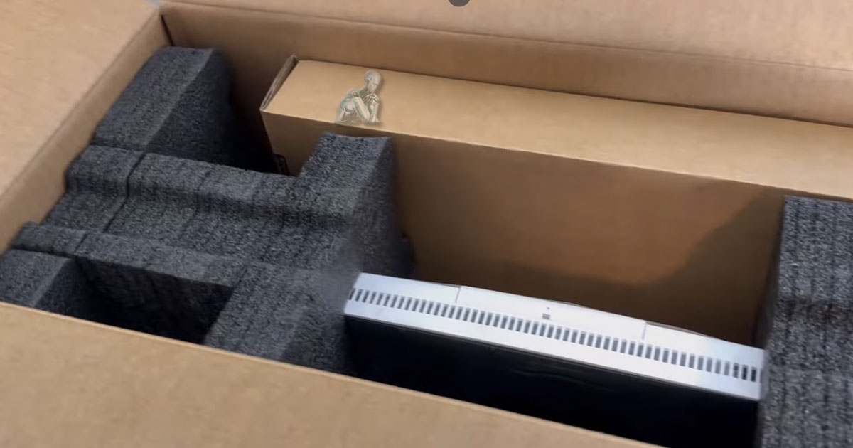 Brand new all-in-one computer inside its original box with packaging materials visible before initial setup and configuration