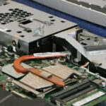 Opened all-in-one computer with CPU fan area being cleaned to remove dust and debris during maintenance