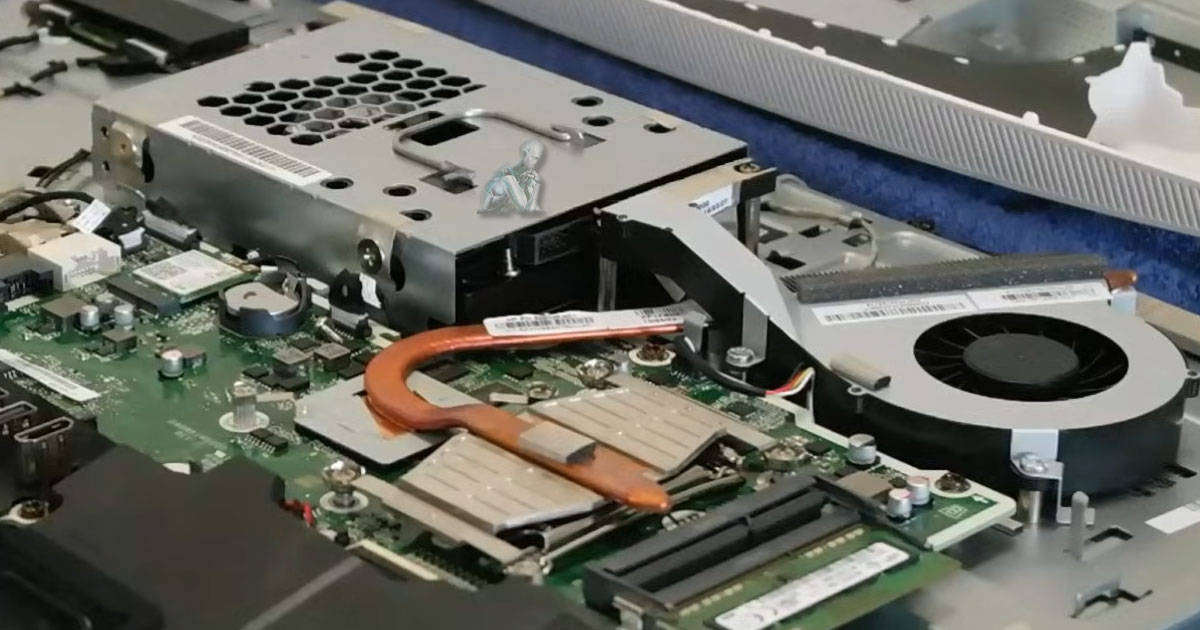 Opened all-in-one computer with CPU fan area being cleaned to remove dust and debris during maintenance