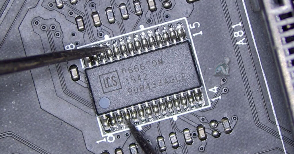 Computer memory slot area on a motherboard with damaged integrated circuits affecting the surrounding board section