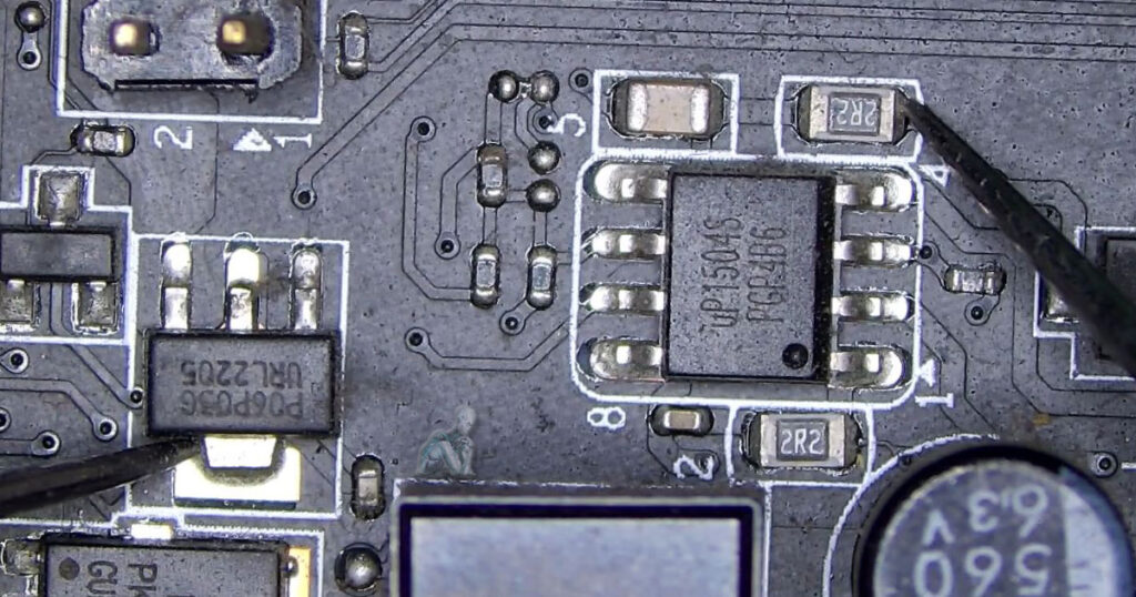 Circuit board section showing a break in continuity along a data transfer pathway, affecting signal flow between components
