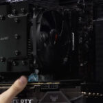 Technician removing a desktop graphics card from the motherboard during diagnostic testing to identify hardware-related issues