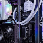 Desktop computer build with upgraded RAM modules, Nvidia graphics card installed, and a CPU water pump cooling system connected within the case