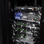 Server cabinet with organized Ethernet cables connected to networking equipment, showing structured wiring inside a rack setup