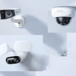 Technician installing a security camera, positioning the unit and securing it during setup