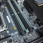 ASUS TUF Gaming motherboard with AMD Ryzen processor and RAM modules arranged for a custom gaming PC build
