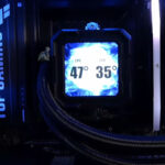 TUF Gaming motherboard installed in a desktop build with a liquid cooling system connected for CPU temperature control