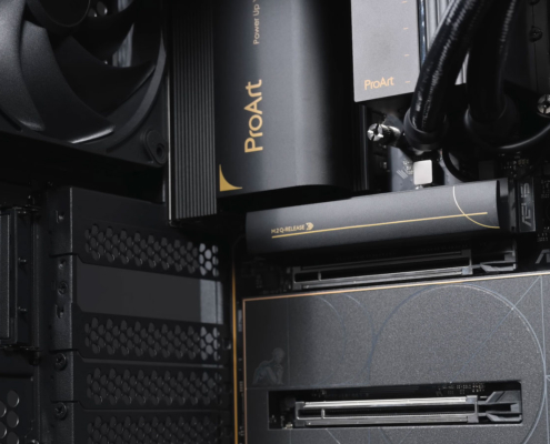 Custom-built gaming PC with multiple RGB fans, high-performance GPU, visible motherboard circuitry, cable routing, and vibrant internal lighting throughout the case