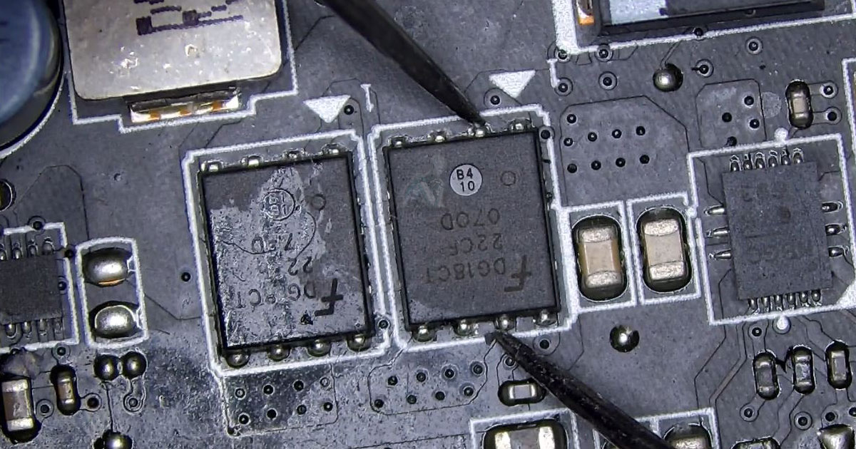 Computer-Repair-Solutions-in-Kendall-FL-for-Everyday-Hardware-Problems Technician examining a motherboard with diagnostic tools, identifying a clearly visible hardware issue among surface-mounted components