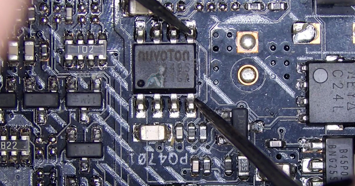 Computer-Repair-and-Hardware-Analysis-Services-in-Miami-Springs-FL Inspection view of a motherboard where multimeter probes are testing a Nuvoton integrated circuit for shorts, with fine solder joints and adjacent components visible