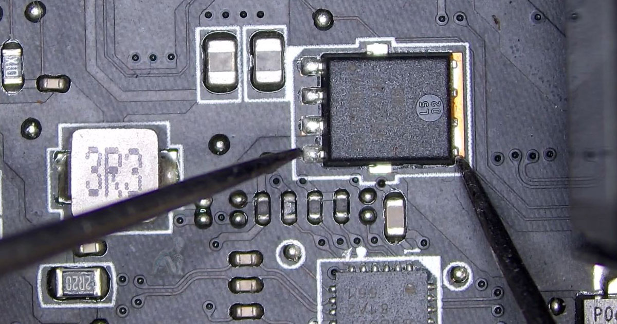 Computer-Repair-in-El-Portal-Miami-Diagnosing-MOSFET-Gate-Failures Close-up of a MOSFET on a motherboard with testing focused on the gate pin, indicating a short condition during electrical diagnostics