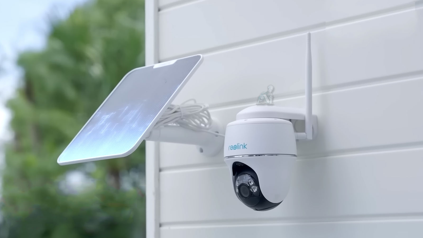 Technician installing a security camera, positioning the unit and securing it during setup