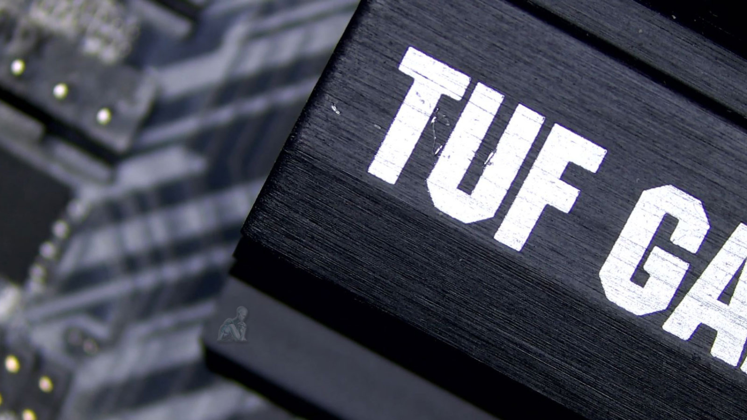 Technician inspecting TUF Gaming desktop motherboard during hardware diagnostic and repair process