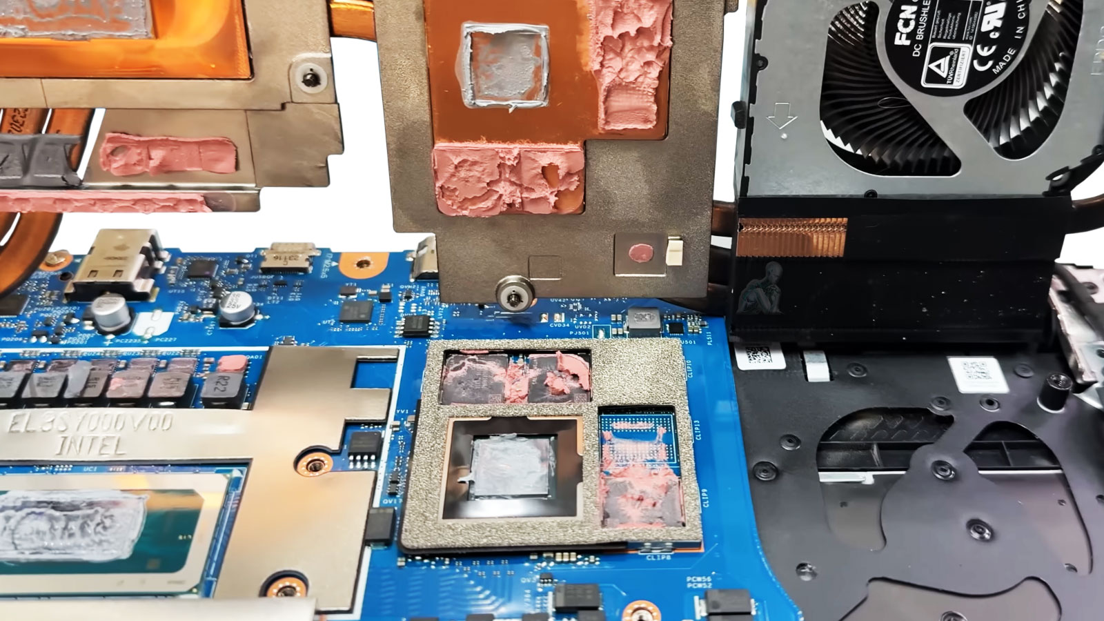 Gaming laptop motherboard with heatsink removed exposing GPU chip and degraded thermal paste and pads