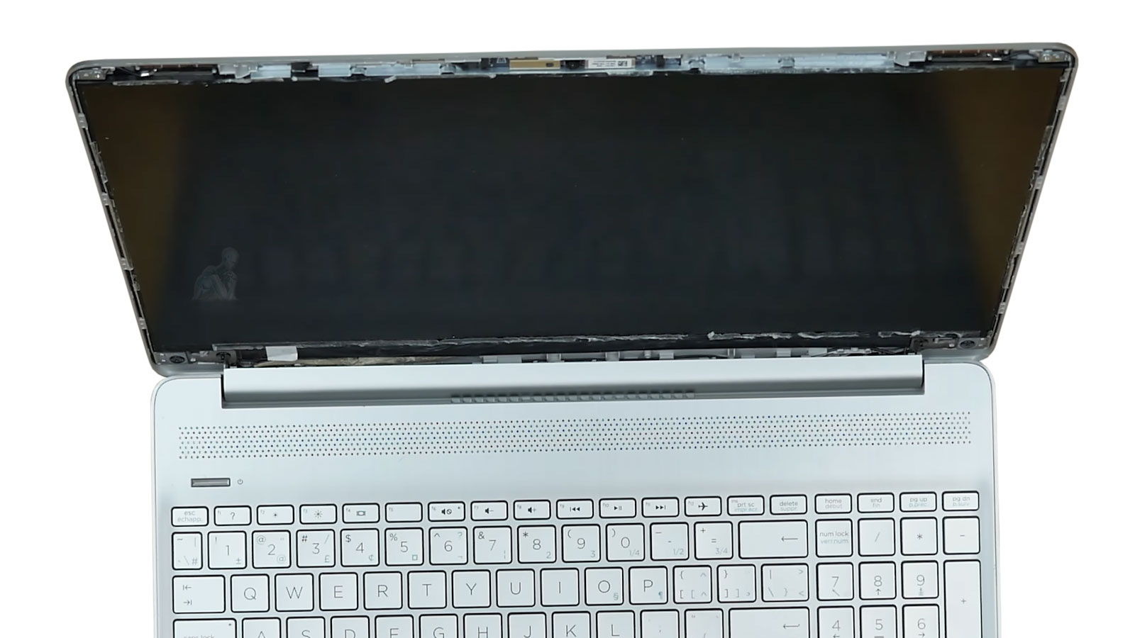 Laptop with front bezel removed exposing LCD screen panel ready for replacement