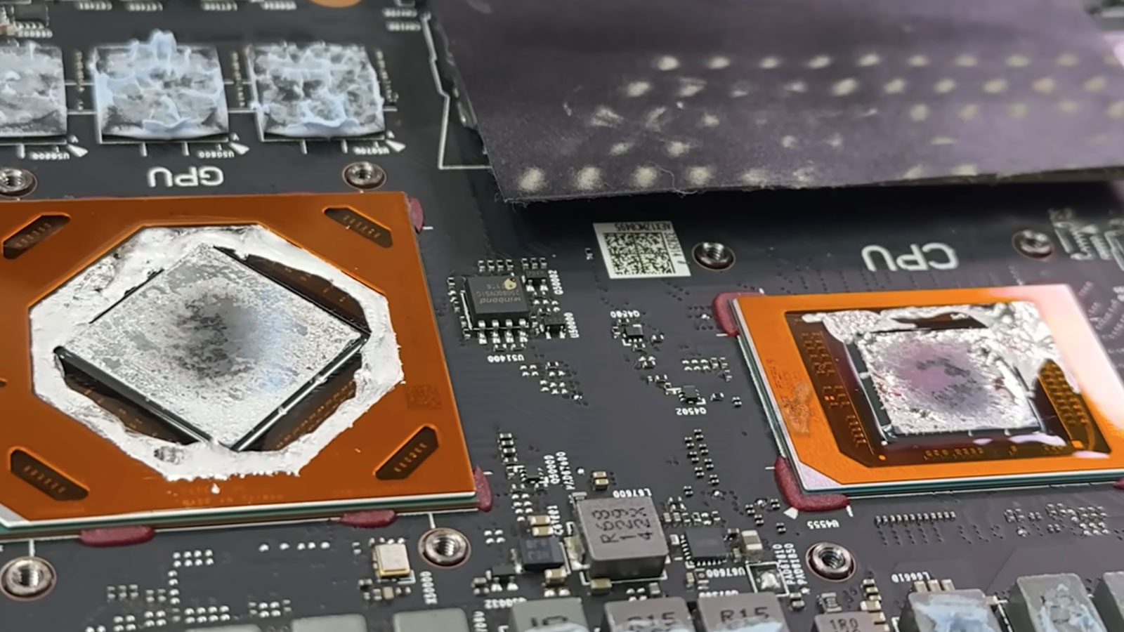 Laptop-Motherboard-CPU-and-GPU-Chipset-Close-Up Close-up of a laptop motherboard showing CPU and GPU chips during internal cleaning and maintenance