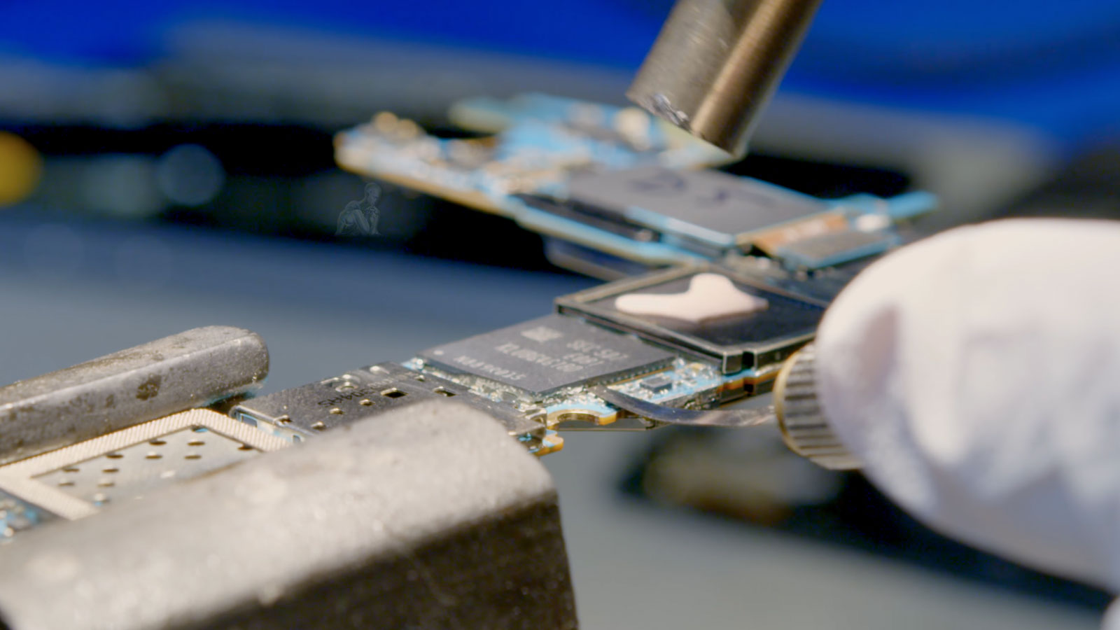NAND chip removal from Mac logic board during advanced data recovery process in Miami