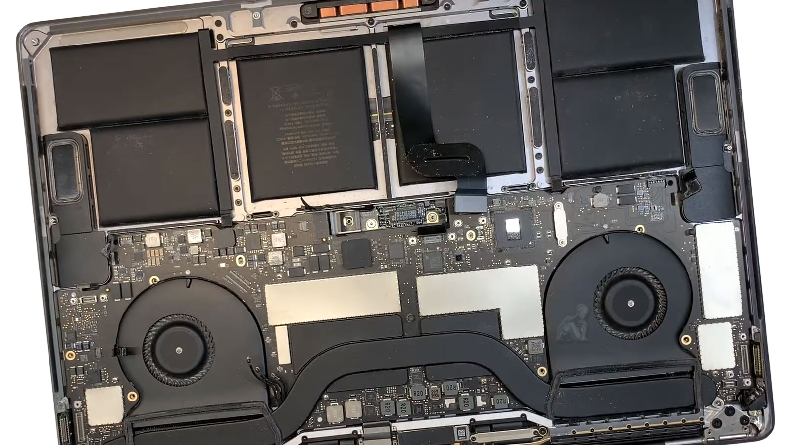 MacBook Air with back cover removed showing charging port and internal components