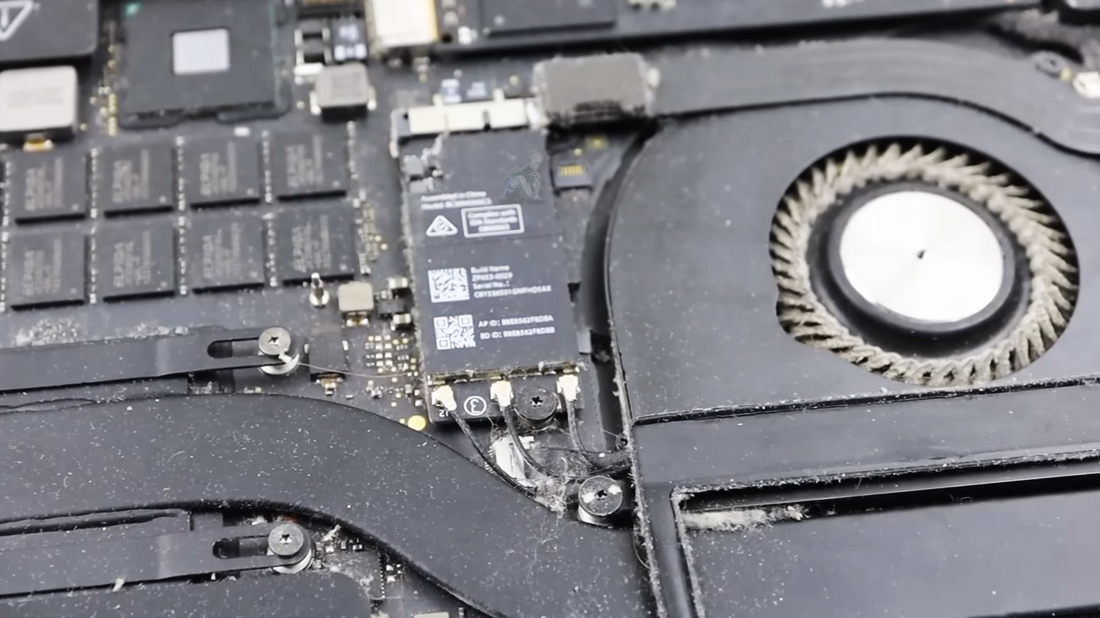 MacBook Air with internal fan heavily clogged by dust and debris