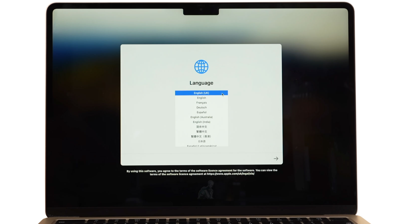 MacBook Air displaying language selection during initial software setup in Miami