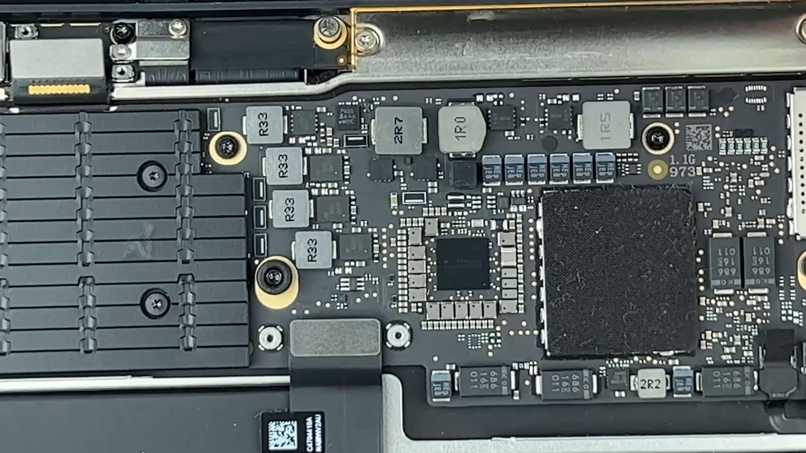 MacBook Air logic board during diagnostic and repair process in Miami