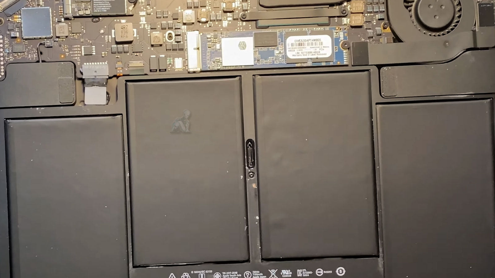 MacBook Air with back cover removed showing the internal battery