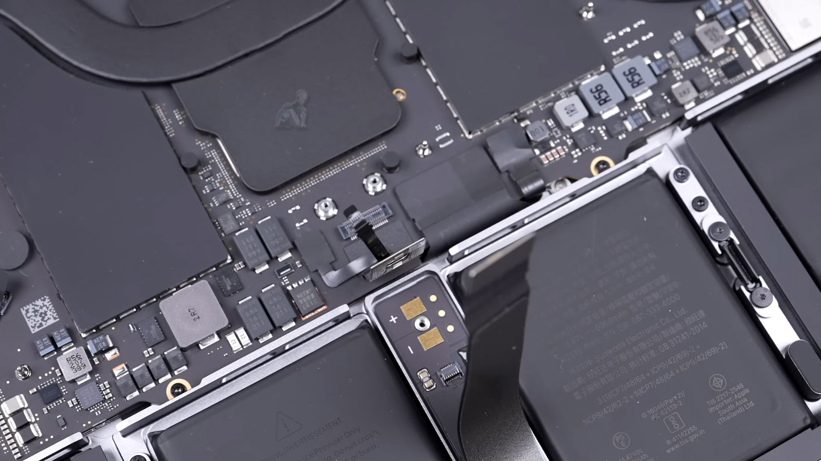 MacBook Air opened with internal components exposed and connectors disconnected during repair preparation in Miami