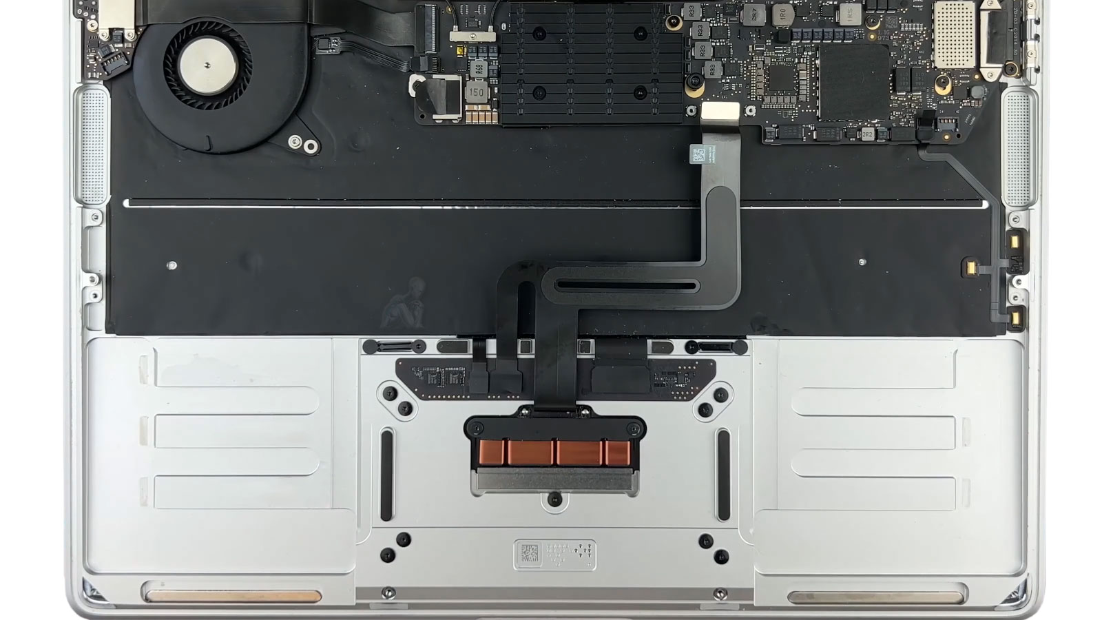 MacBook Pro with battery removed during replacement process in Miami
