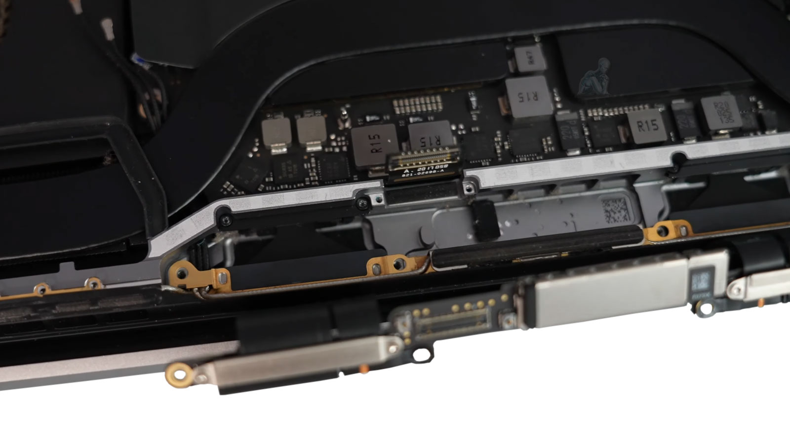 Technician disconnecting MacBook Pro LCD display cable from logic board during repair