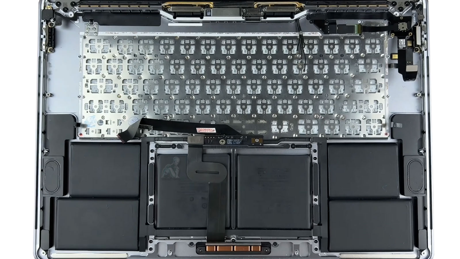 Technician replacing MacBook Pro keyboard during repair procedure