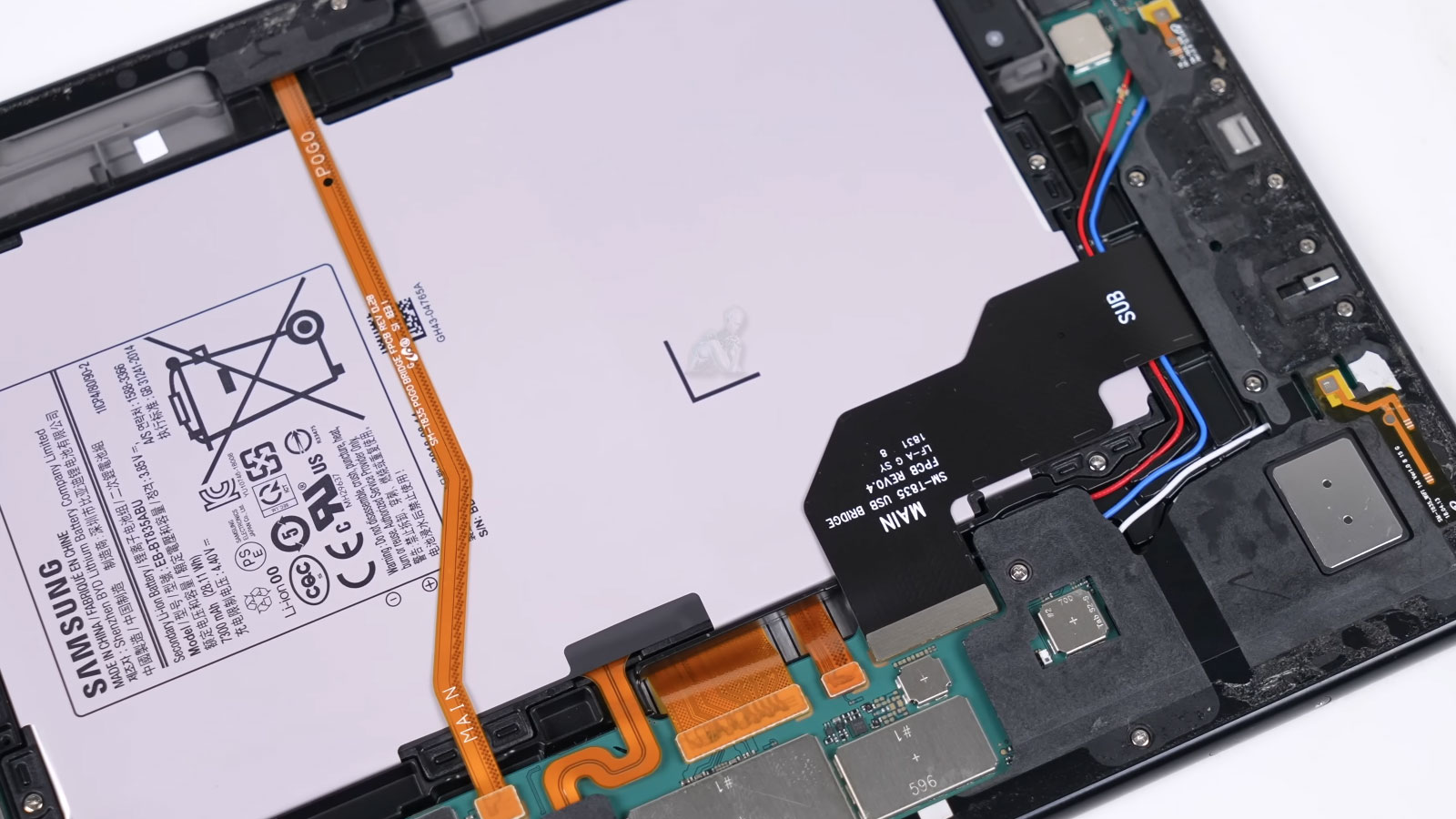 Samsung tablet opened with back cover removed showing internal components during repair