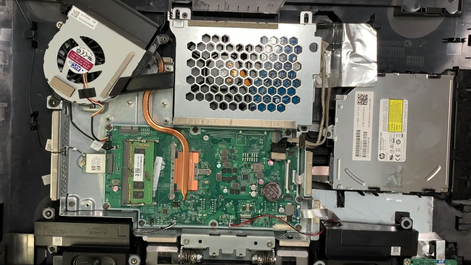 all-in-one-power-supply-repair-internal-view All-in-one desktop opened with internal components exposed showing motherboard and power supply section