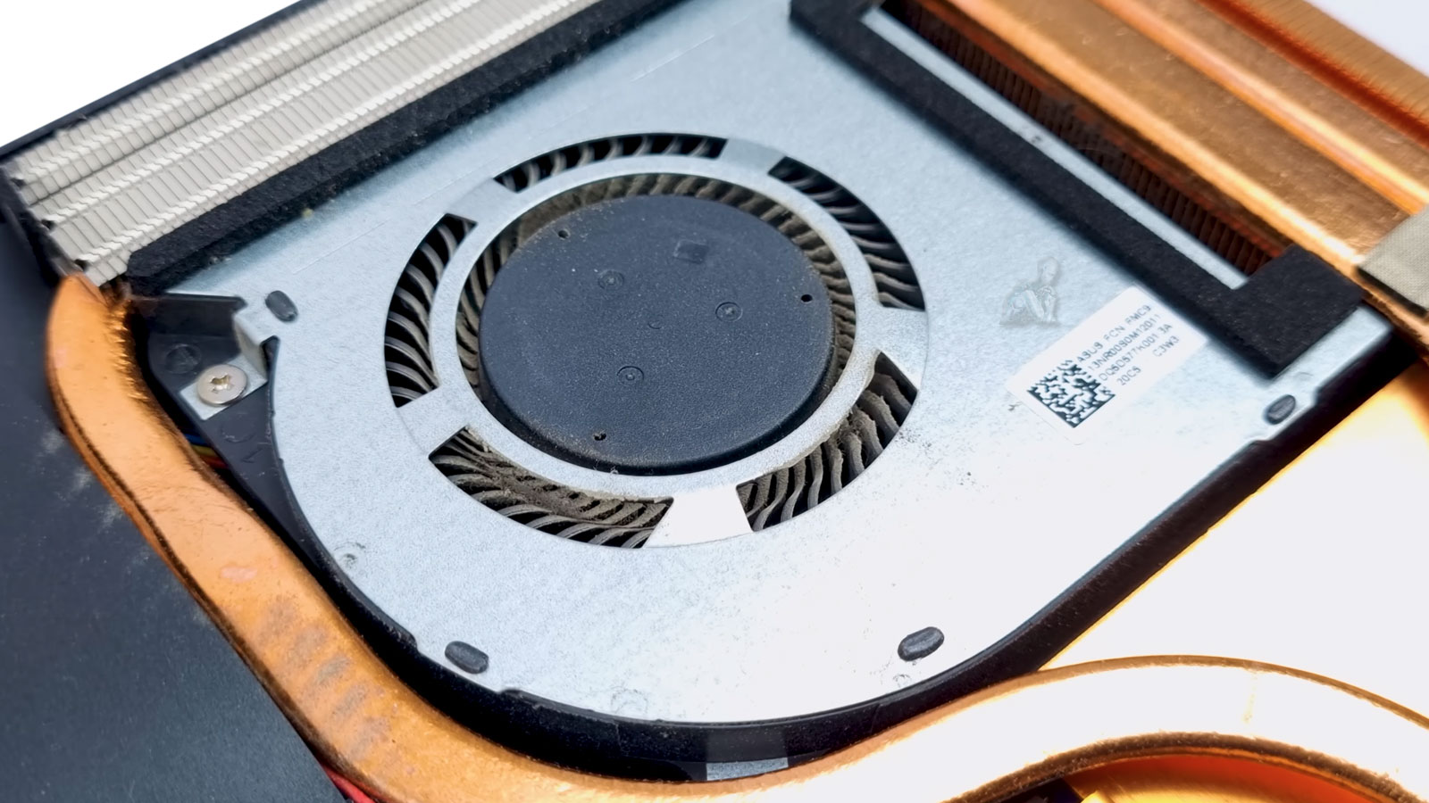 gaming-laptop-fan-dust-cleaning-service Gaming laptop opened showing dust buildup on cooling fans near CPU