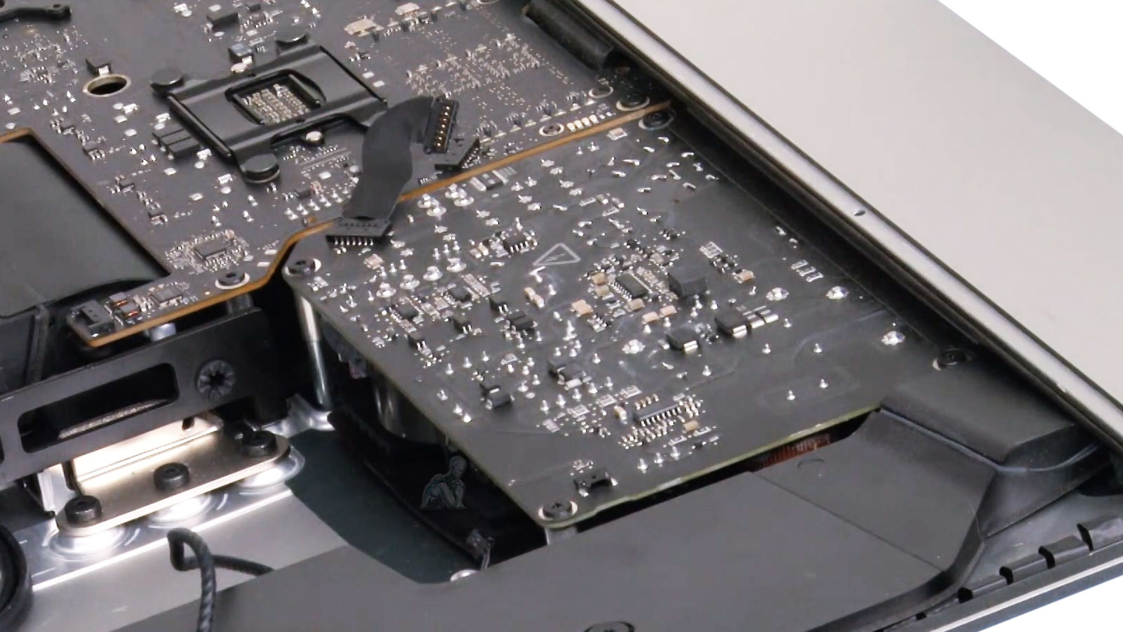 Open iMac with LCD screen removed showing internal components during cleaning and maintenance