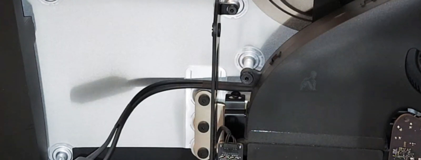 Open iMac with display removed showing internal circuit boards during diagnostic inspection