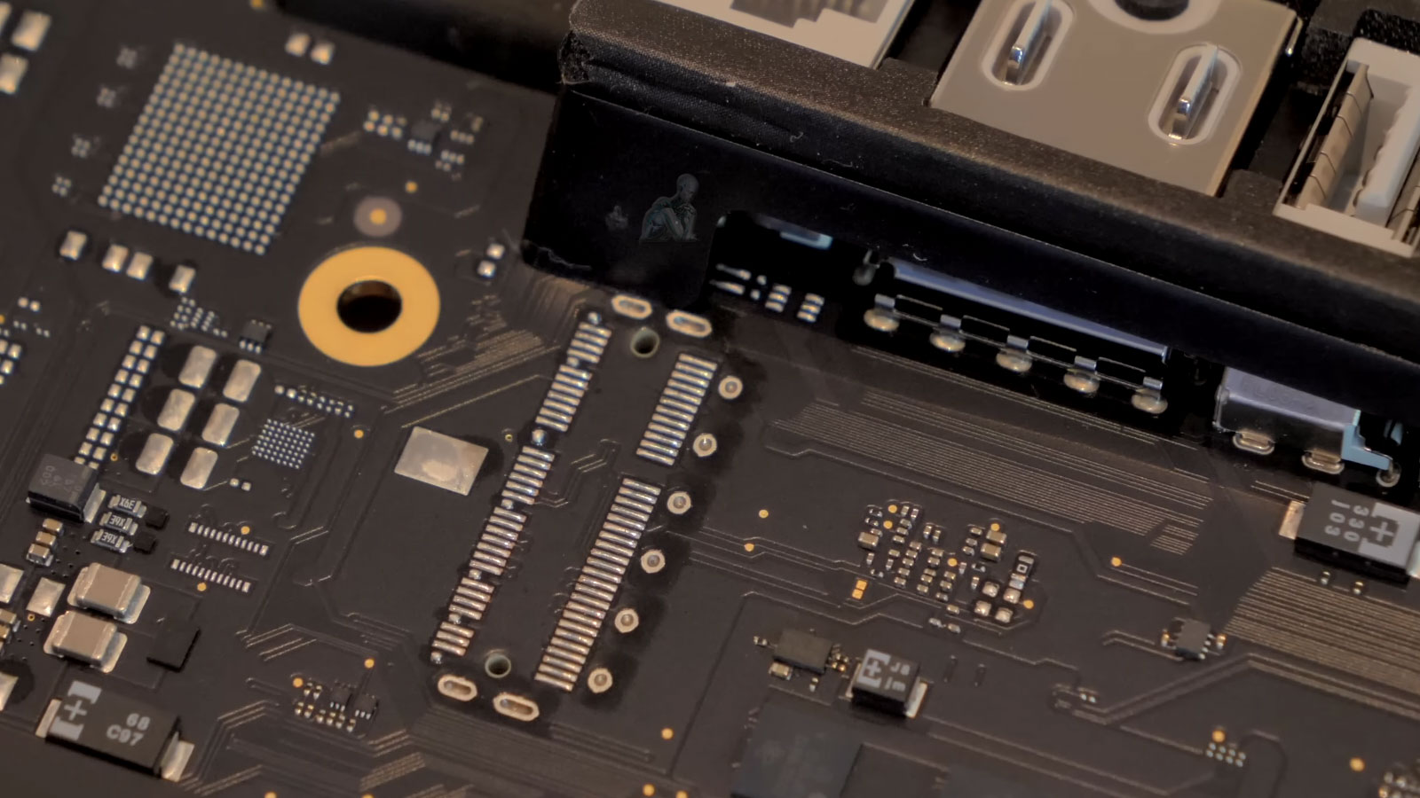 iMac motherboard removed and placed on work surface for logic board repair and inspection
