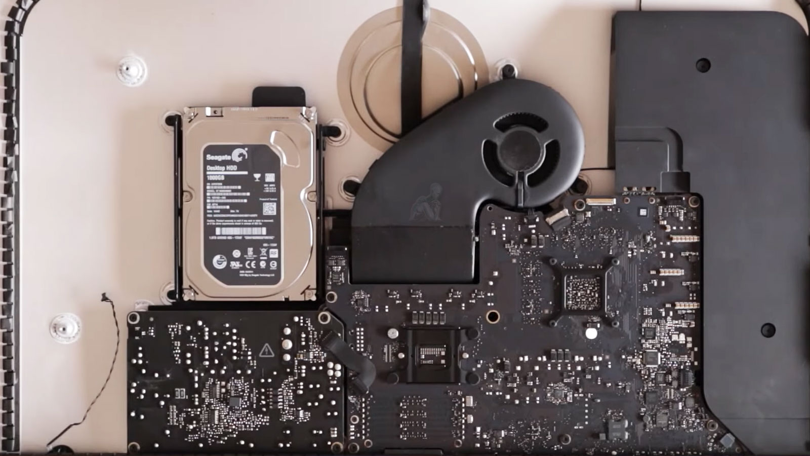 Open iMac with internal hard drive exposed prepared for SSD replacement upgrade