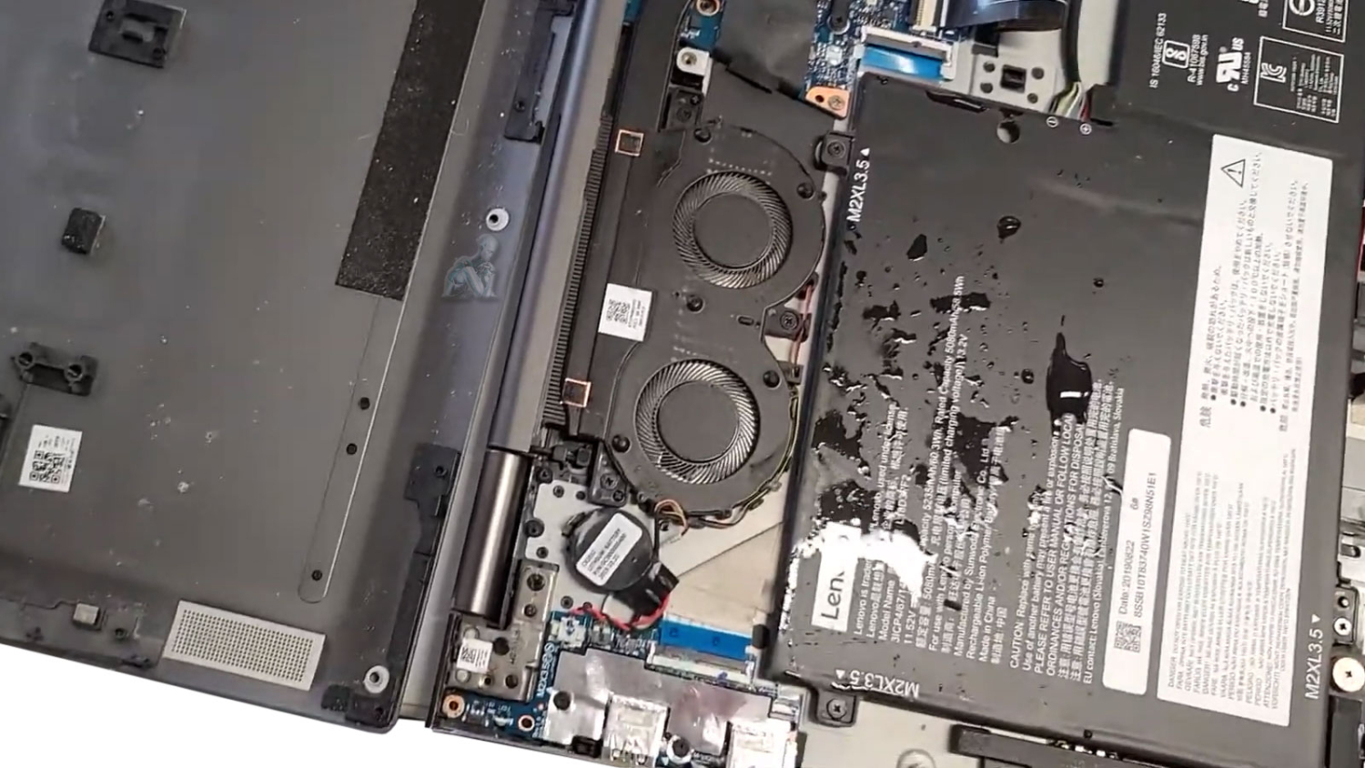 Open laptop showing liquid damage on internal components during laptop repair in Miami