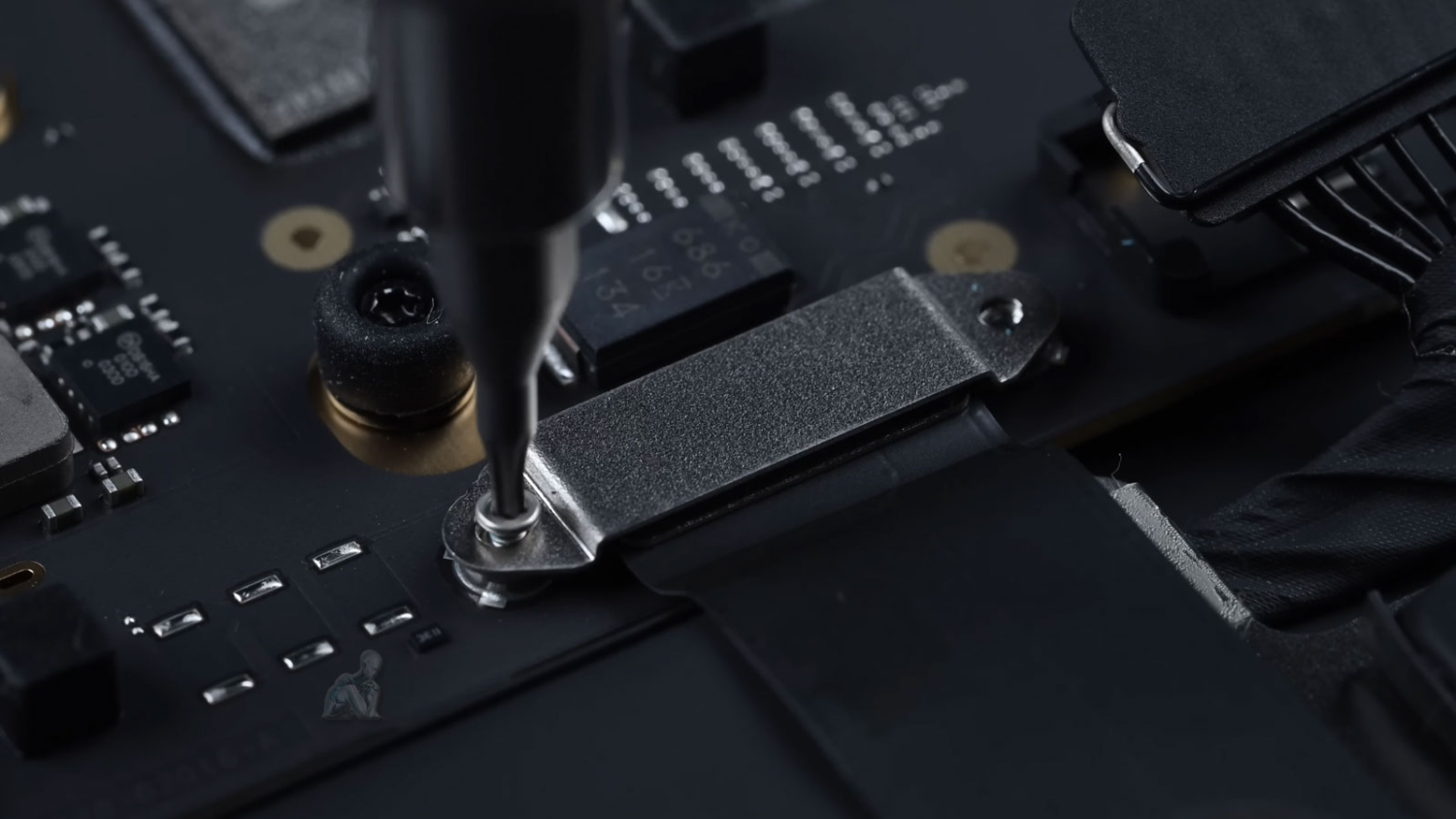 MacBook open with logic board exposed during Mac repair in Miami