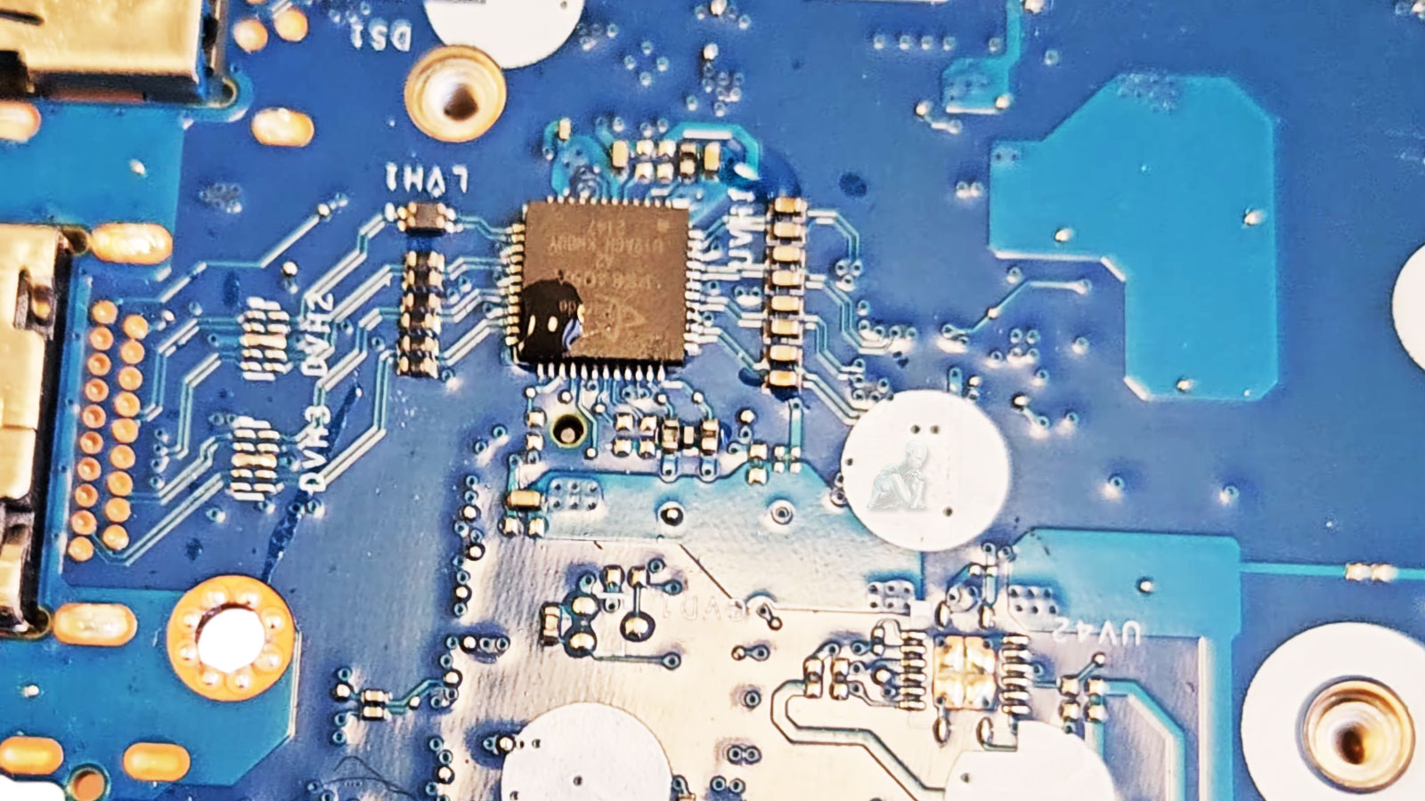 Liquid Damage on a Laptop Motherboard Laptop motherboard showing liquid damage and corrosion around an integrated circuit.